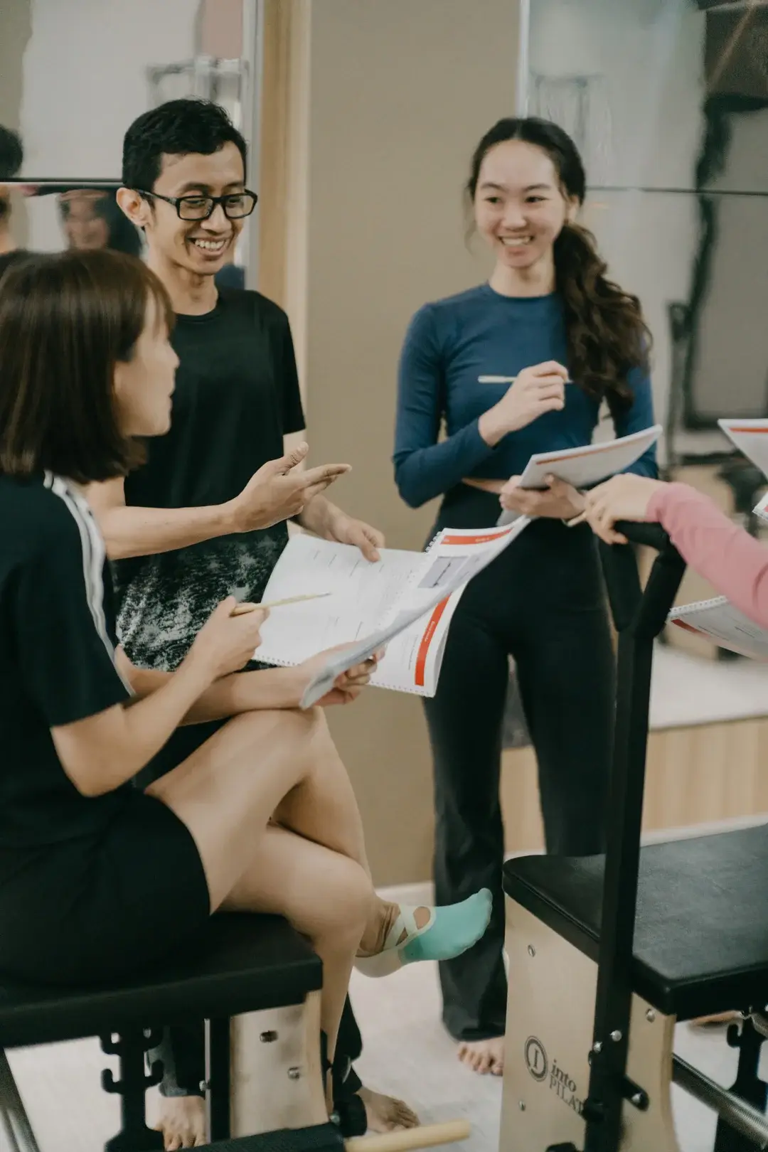 Students at Raia Instructor Academy going through course notes together in the studio